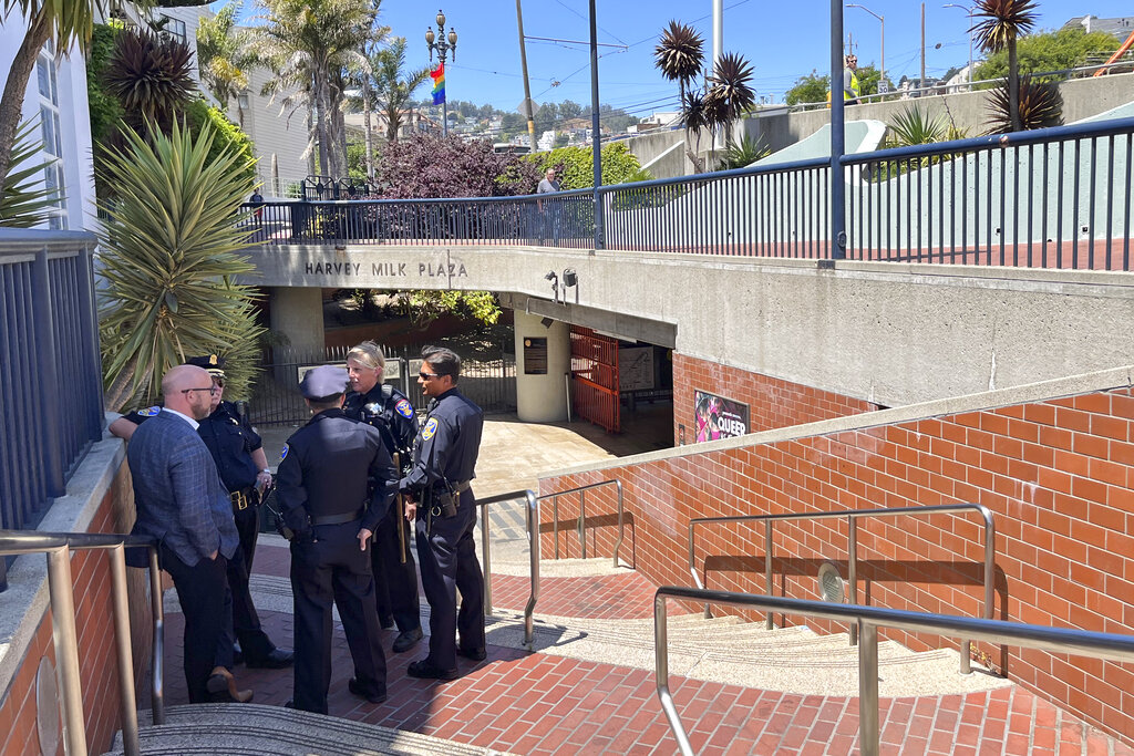 Police personnel confer outside the entrance to the Castro Muni Metro station following a shooting in San Francisco, Wednesday, June 22, 2022. One person was killed and another was wounded in a shooting on a crowded subway train early Wednesday, Supervisor Myrna Melgar said.  (AP Photo/Janie Har)