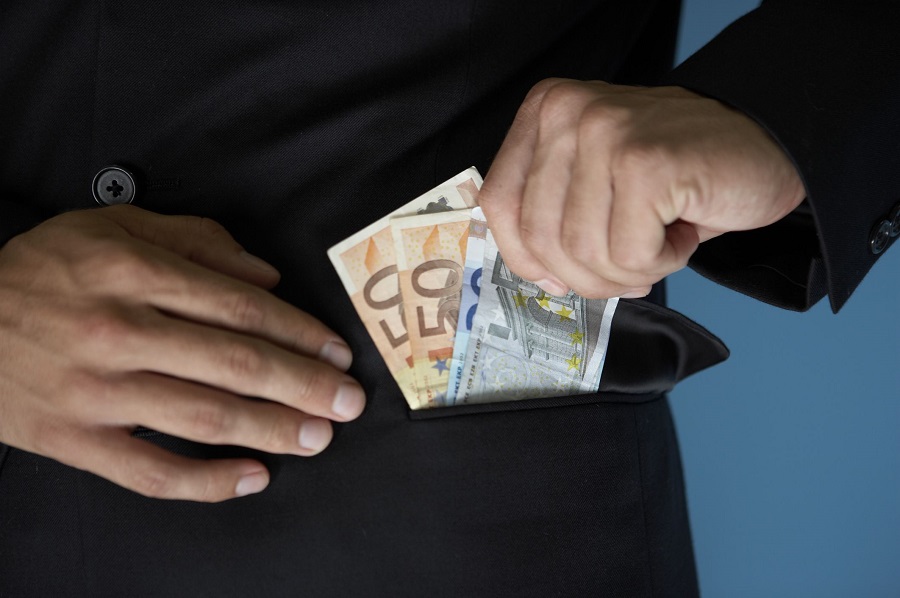 Businessman putting money in pocket