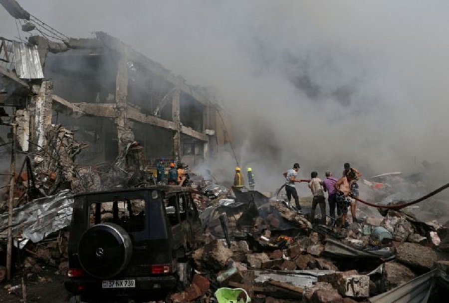 People help firefighters to extinguish a fire after blasts ripped through a fireworks warehouse in a shopping mall in Yerevan, Armenia August 14, 2022. Vahram Baghdasaryan/Photolure via REUTERS ATTENTION EDITORS - THIS IMAGE HAS BEEN SUPPLIED BY A THIRD PARTY.     TPX IMAGES OF THE DAY