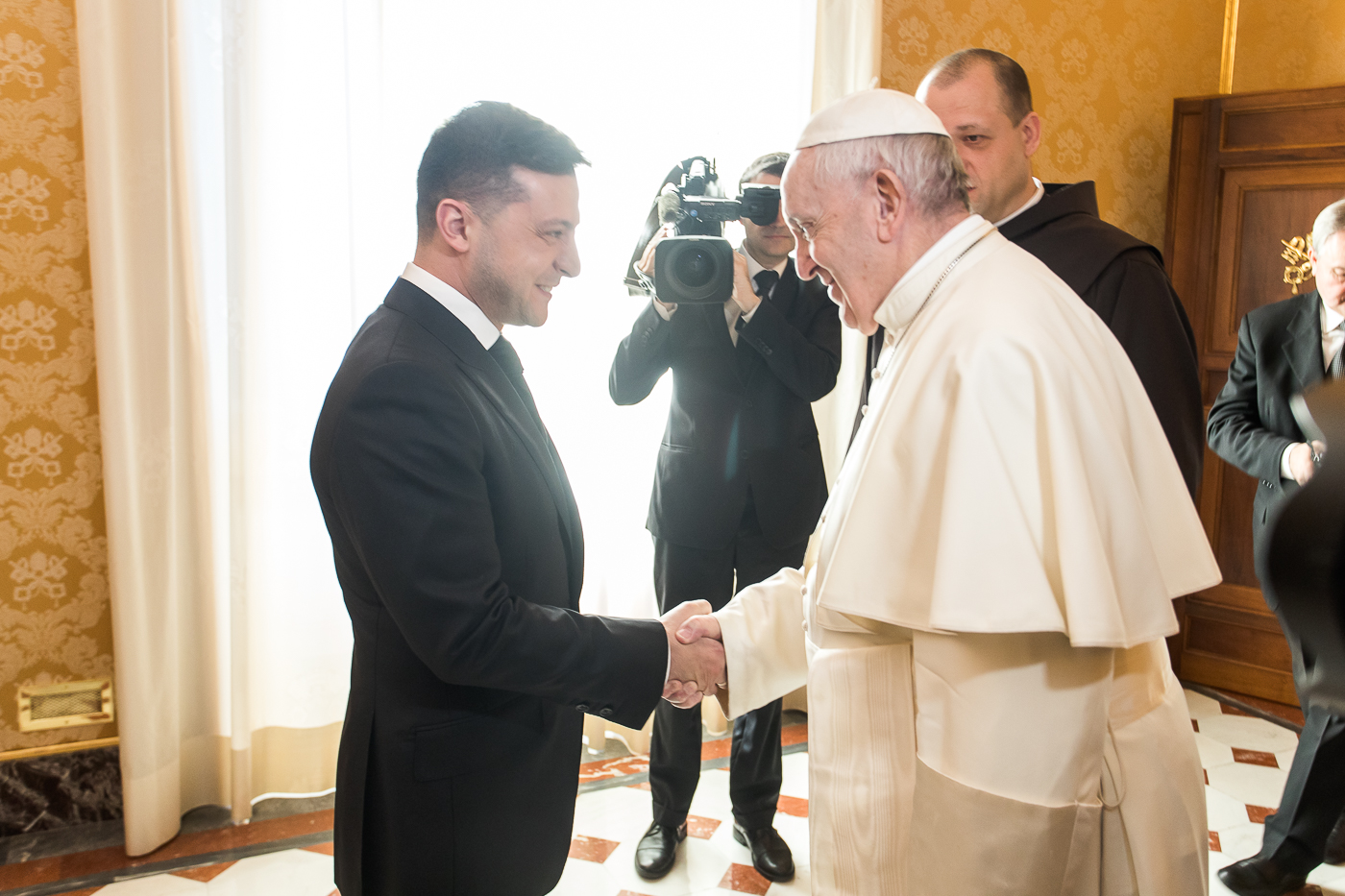 Pope Francis shakes hands with Ukrainian President Volodymyr Zelensky (L) during a private audience at the Vatican, on Feb. 8, 2020.