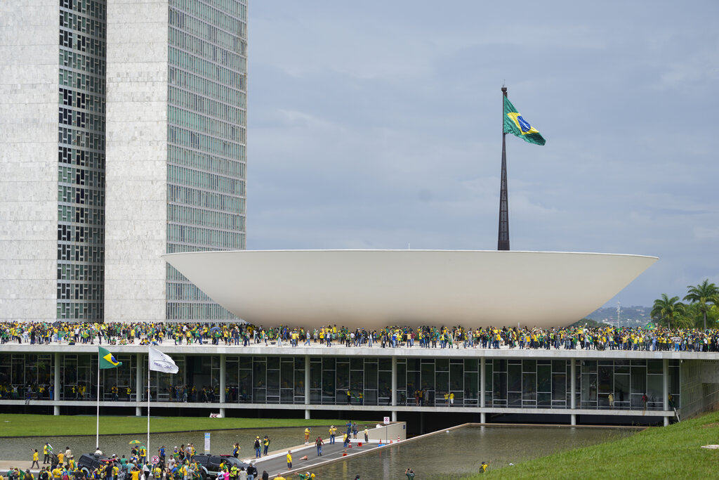 Protesters, supporters of Brazil's former President Jair Bolsonaro, storm the the National Congress building in Brasilia, Brazil, Sunday, Jan. 8, 2023. (AP Photo/Eraldo Peres)