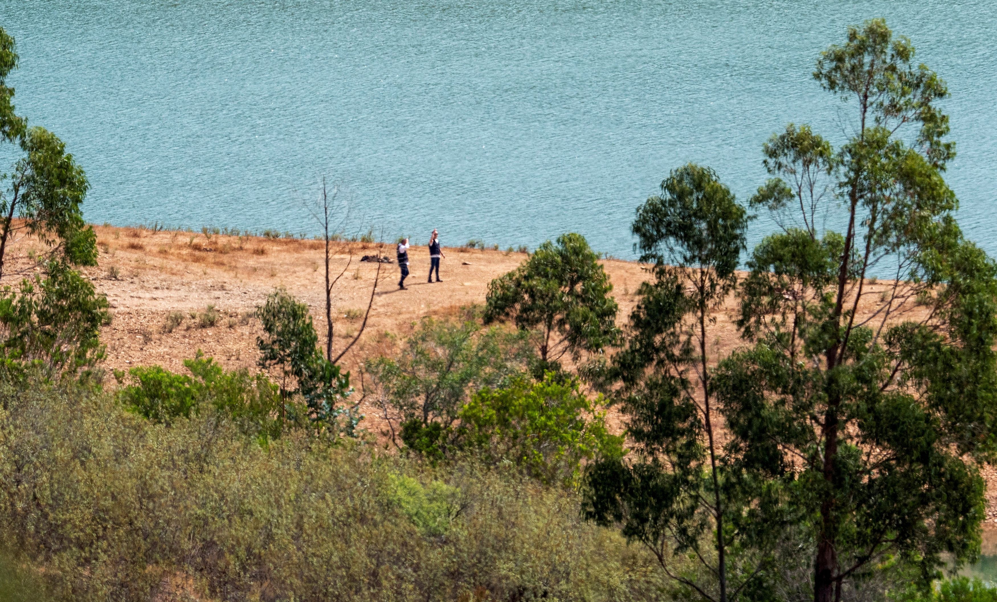 Officers of Portugal's investigative Judicial Police are seen at the site of a remote reservoir where a new search for the body of Madeleine McCann is set to take place, in Silves, Portugal, in this screen grab from a video, May 22, 2023. REUTERS/Luis Ferreira       NO RESALES. NO ARCHIVES.