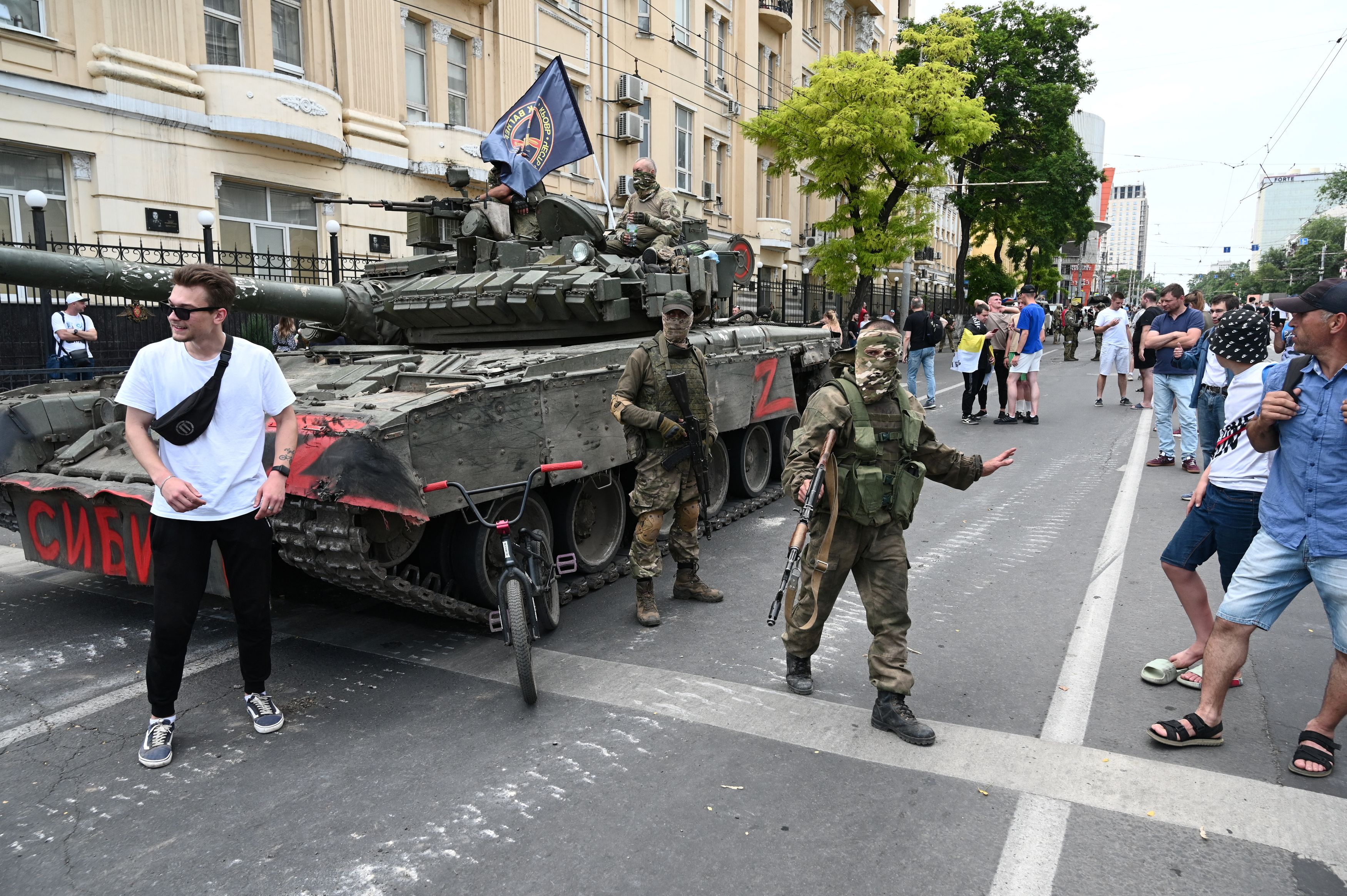 People gather in a street as fighters of Wagner private mercenary group are deployed near the headquarters of the Southern Military District in the city of Rostov-on-Don, Russia, June 24, 2023. REUTERS/Stringer