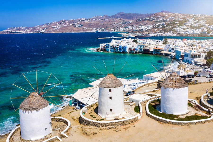 Aerial view through the famous windmills above Mykonos town, Cyclades, Greece, to the Little Venice district