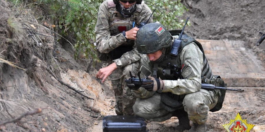 A fighter from Russian Wagner mercenary group and a Belarusian service member take part in a joint training outside Brest