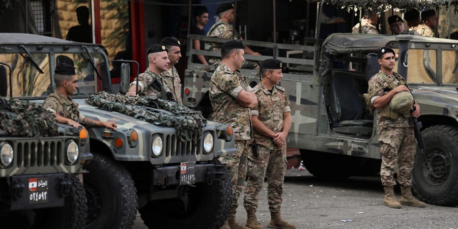 Lebanese army members secure the area where a truck overturned yesterday night, in the town of Kahaleh, Lebanon, August 10, 2023. REUTERS/Mohamed Azakir