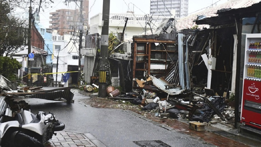 Damaged buildings are seen in Naha, south of Okinawa, Japan, Wednesday, Aug. 2, 2023, as a typhoon was was affecting the Okinawa islands. A powerful typhoon slammed Okinawa and other islands in southwestern Japan Wednesday with high winds injuring multiple people as it moved west making its way toward mainland China. (Kyodo News via AP)