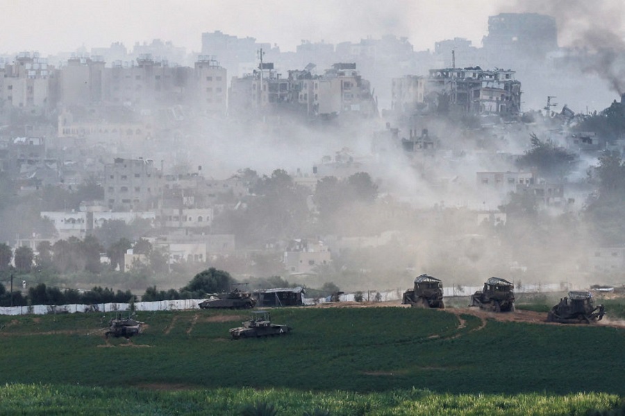 Israeli tanks and  other military vehicles manoeuvre inside the Gaza Strip, as seen from Israel