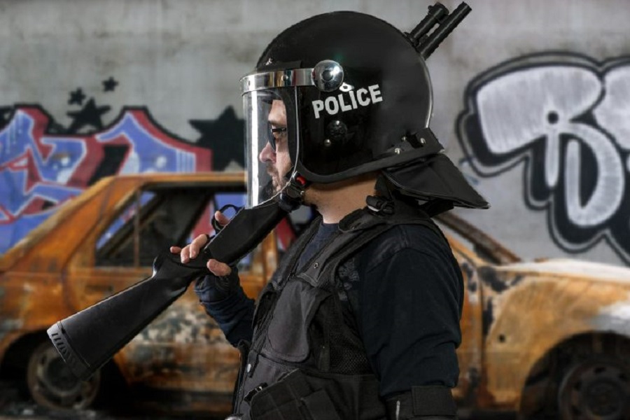 armed-police-with-riot-helmet-vest-scene-with-burnt-car-riots-jpg