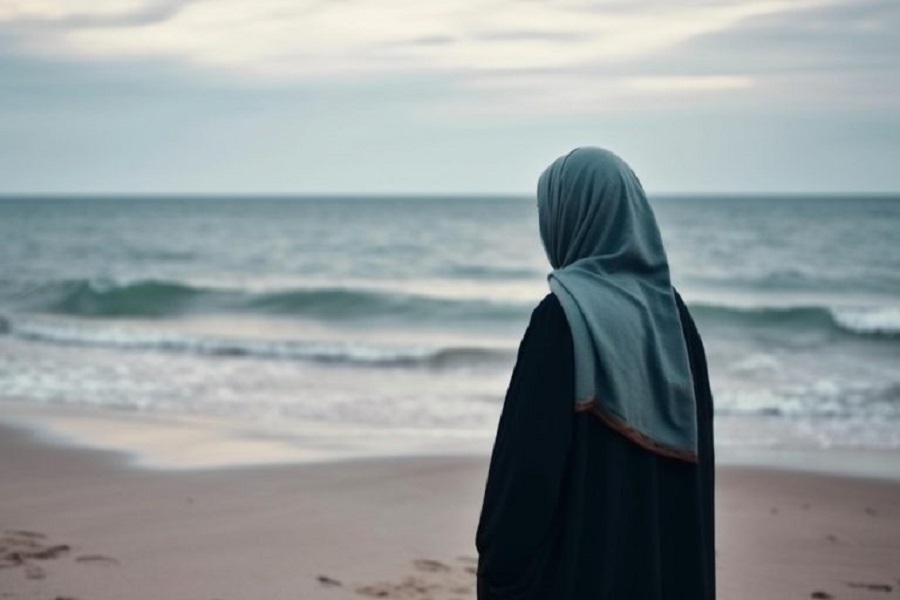 unrecognizable-woman-hijab-standing-beach-looking-horizon-