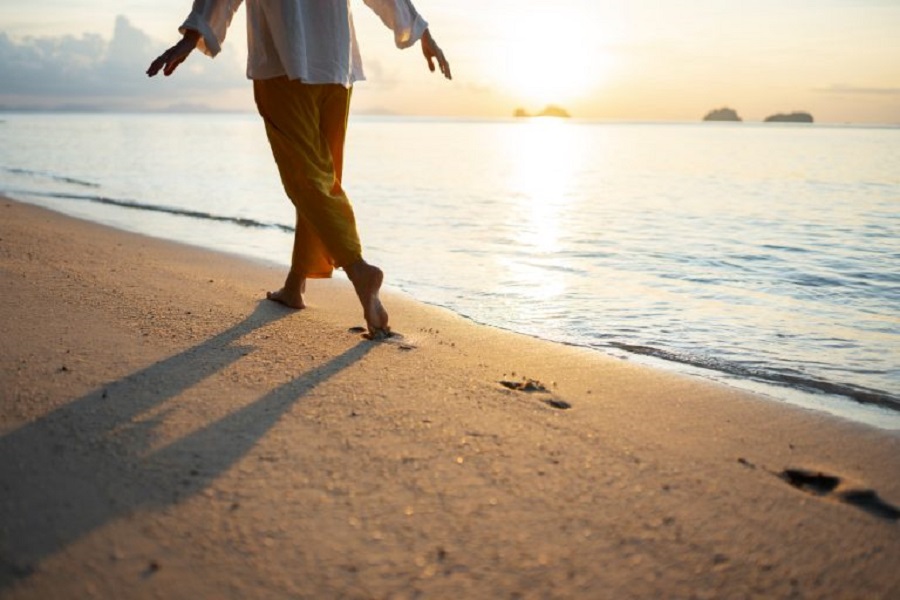 woman-walking-beach-back-view-