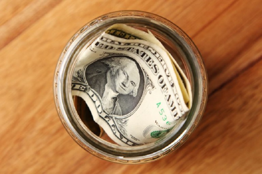 high-angle-shot-american-dollar-bills-glass-jar-wooden-surface