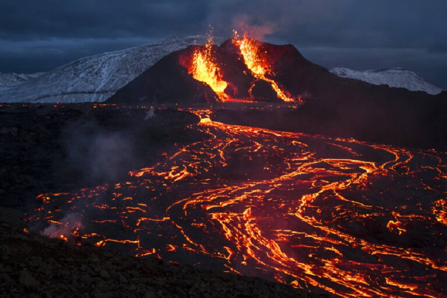 Lava flows from an eruption of a volcano on the Reykjanes Peninsula in southwestern Iceland on Monday, March 29, 2021. Iceland's latest volcano eruption is still attracting crowds of people hoping to get close to the gentle lava flows. (AP Photo/Marco Di Marco)