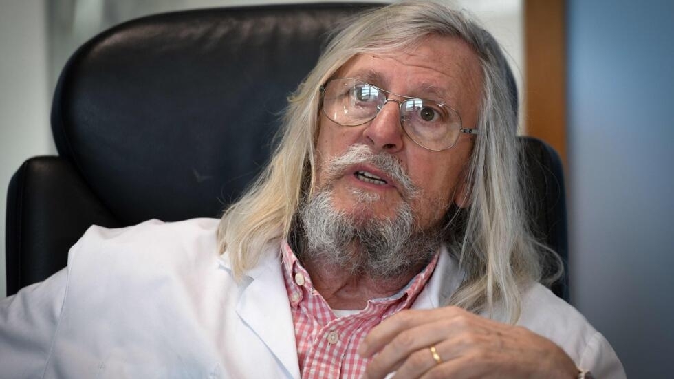 A picture taken on February 26, 2020 shows French professor Didier Raoult, biologist and professor of microbiology, specialized in infectious diseases and director of IHU Mediterranee Infection Institute posing in his office in Marseille, southeastern France. - Raoult reported this week that after treating 24 patients for six days with Plaquenil, the virus had disappeared in all but a quarter of them. The research has not yet been peer reviewed or published, and Raoult had come under fire by some scientists and officials in his native France for potentially raising false hopes. (Photo by GERARD JULIEN / AFP)