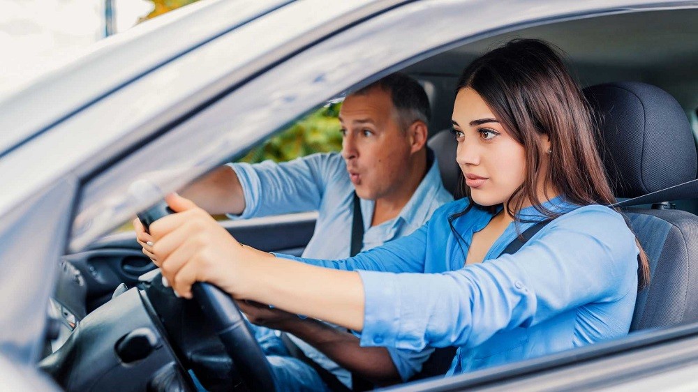 211104115910_woman-student-driver-sitting-scared-in-car-with-instructor-1