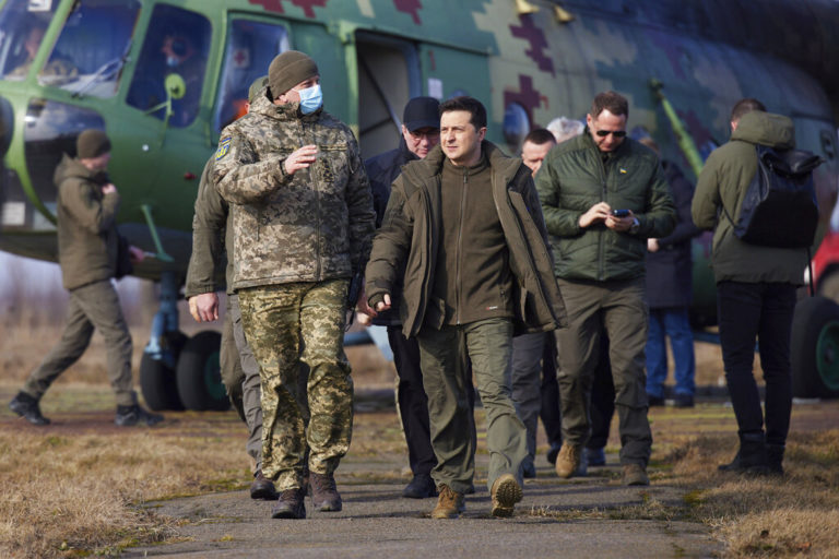 Ukrainian President Volodymyr Zelenskyy, center, arrives to attend a military drill outside the city of Rivne, northern Ukraine, Wednesday, Feb. 16, 2022. (Ukrainian Presidential Press Office via AP)