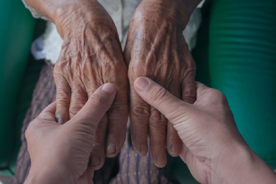 young-woman-holding-elderly-woman-s-hand-