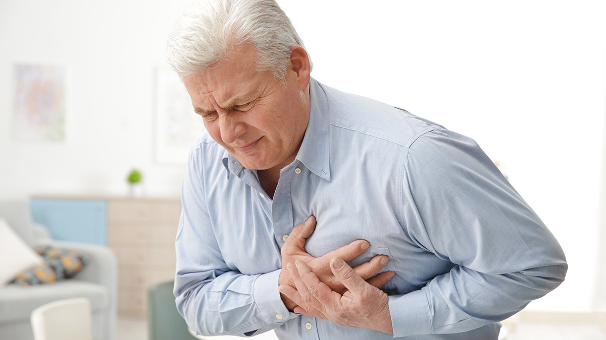 Man with chest pain suffering from heart attack in office