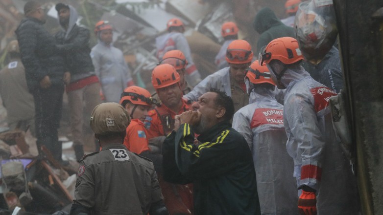 A relative reacts as rescue workers save a 4-year-old girl who was rescued from her collapsed house after heavy rains in Petropolis, Rio de Janeiro state, Brazil, Saturday, March 23, 2024. (AP Photo/Bruna Prado)