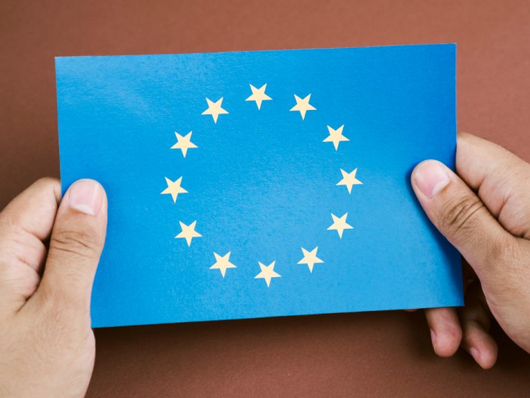 front-view-man-holding-card-with-european-union-flag