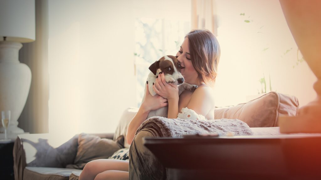 Beautiful,Young,Woman,Sitting,On,The,Sofa,And,Hugging,Her