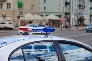 police-car-lightbar-closeup-against-city-street-