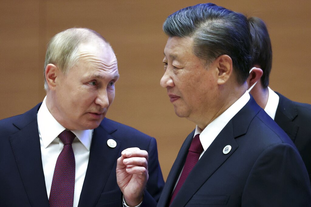 Russian President Vladimir Putin, left, gestures while speaking to Chinese President Xi Jinping during the Shanghai Cooperation Organization (SCO) summit in Samarkand, Uzbekistan, Friday, Sept. 16, 2022. (Sergei Bobylev, Sputnik, Kremlin Pool Photo via AP)