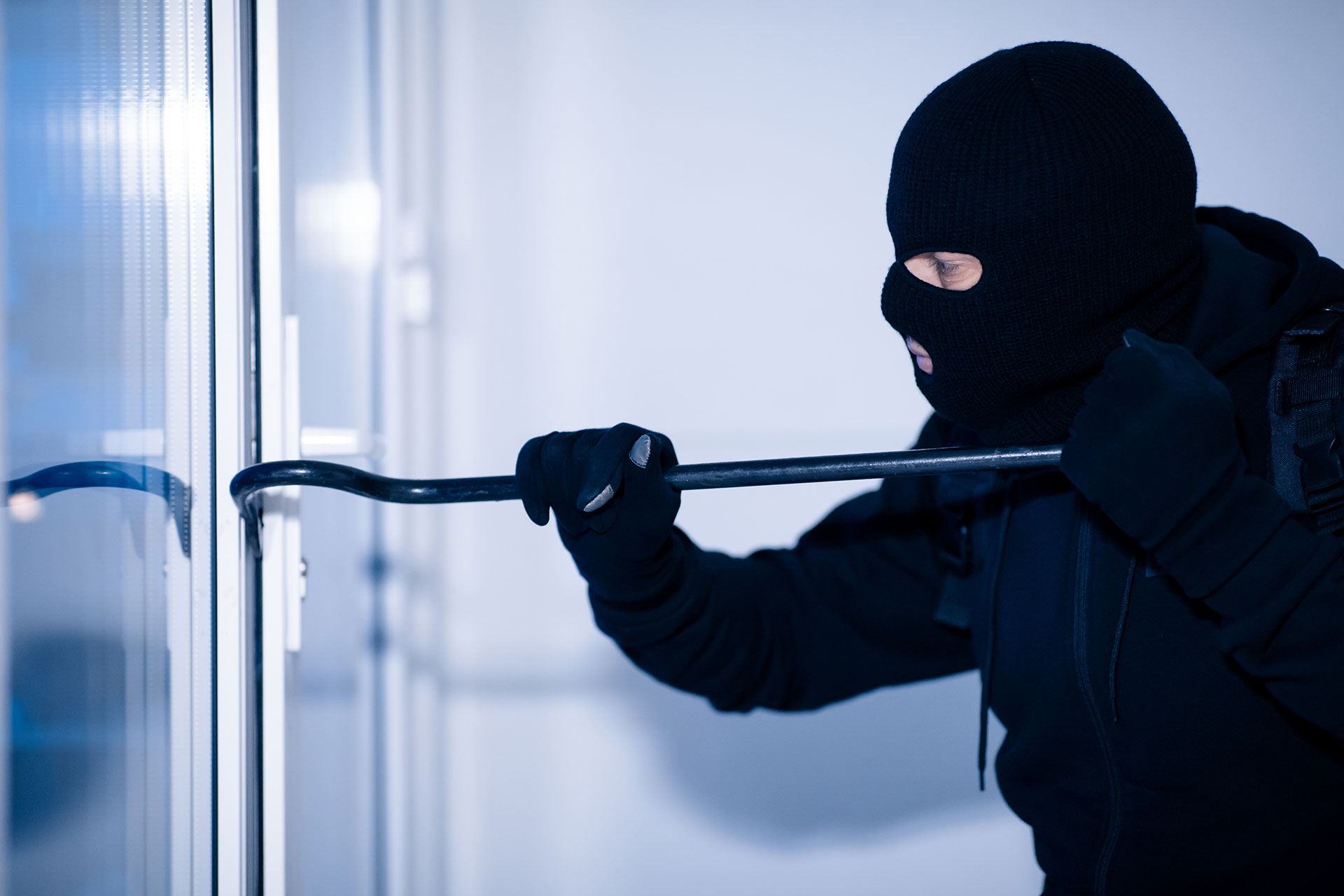 robber-in-black-balaclava-cracking-door-with-crow