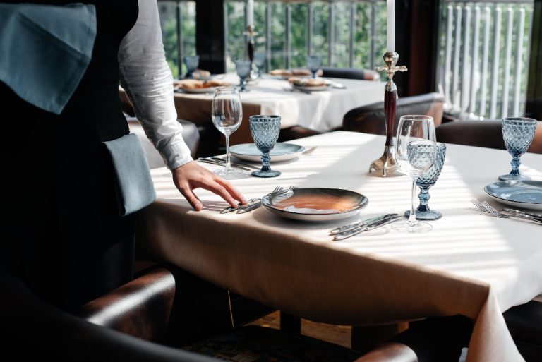 young-waiter-stylish-uniform-is-engaged-serving-table-beautiful-gourmet-restaurant-closeup-table-service-restaurant