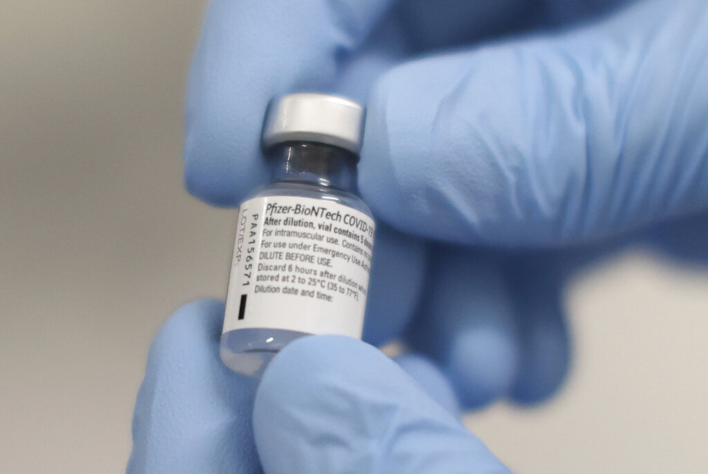 A phial of the Pfizer-BioNTech COVID-19 vaccine at the Royal Victoria Hospital, in Belfast, Tuesday Dec. 8, 2020. The United Kingdom, one of the countries hardest hit by the coronavirus, is beginning its vaccination campaign, a key step toward eventually ending the pandemic. (Liam McBurney/Pool via AP)