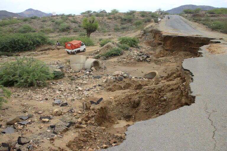 A truck drives near a road that was damaged by flooding near the city of Abs in southwest Yemen after heavy seasonal rains in country have resulted in rising floodwaters on Thursday, Aug. 8, 2024.   (AP Photo/ Eissa Ahmed)