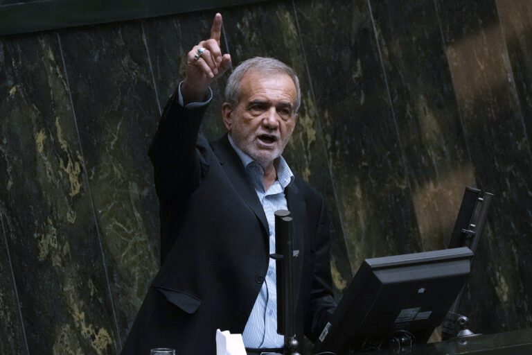 Iranian President Masoud Pezeshkian speaks in an open session of parliament to debate on his proposed ministers, in Tehran, Iran, Saturday, Aug. 17, 2024. (AP Photo/Vahid Salemi)