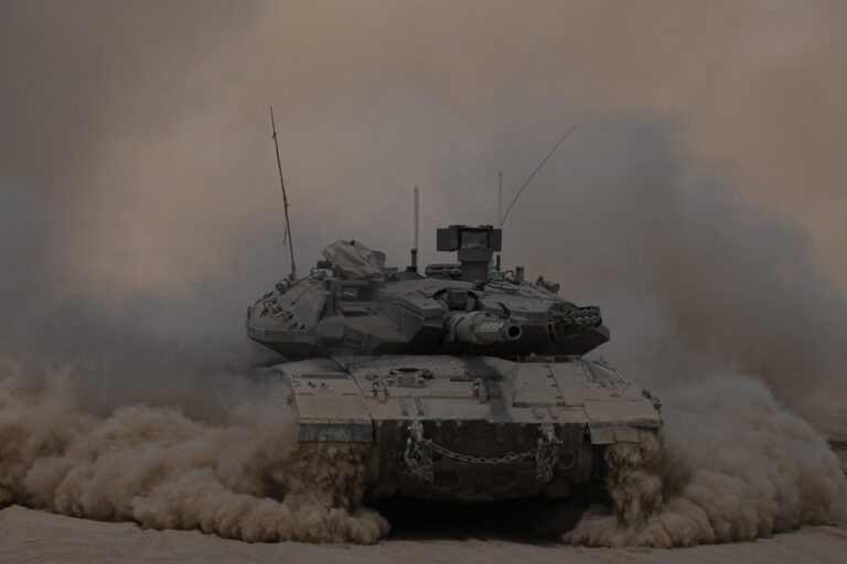 An Israeli tank manoeuvres near the Israel-Gaza border, southern Israel, Thursday, Aug. 29, 2024. (AP Photo/Tsafrir Abayov)