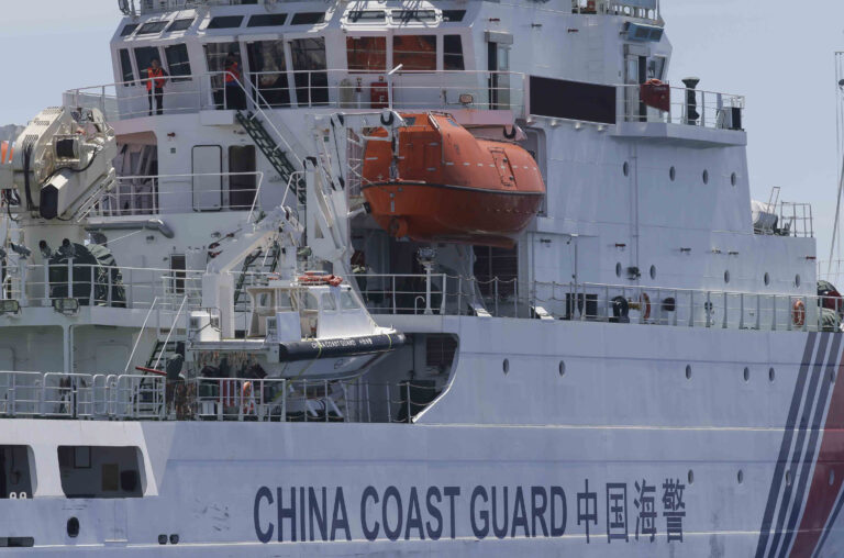 A crew of the China Coast Guard vessel watch a Philippine Government vessel as they attempt to block the latter from entering the Second Thomas Disputed Shoals (local name Ayungin Shoal) to resupply and replace Philippine Marines who were deployed for almost five months now Saturday, March 29, 2014. Chinese coast guard ships set up a blockade but a lone Philippine boat maneuvered past them in the high seas Saturday to deliver a fresh batch of Filipino troops and food supplies to a disputed shoal in a tense, cat-and-mouse-like confrontation witnessed for the first time by journalists in the South China Sea. (AP Photo/Bullit Marquez)