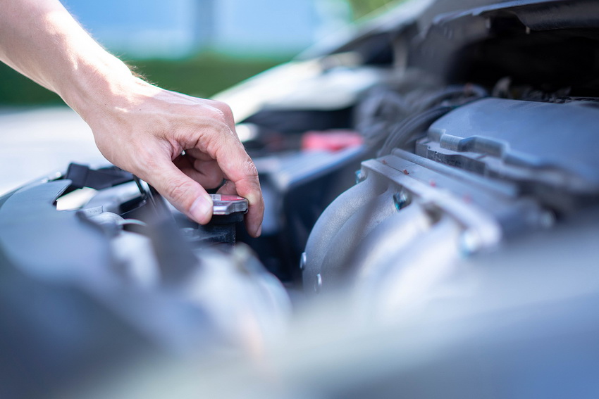 Man hand checking level of coolant car engine. Check and maintenance the coolant in car with yourself.