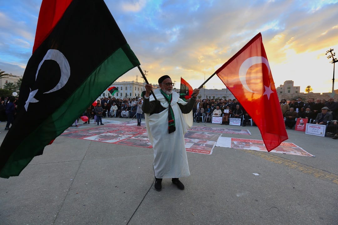 TRIPOLI, LIBYA - JANUARY 10: An old man holds flags of Turkey and Libya during a demonstration against eastern military commander Khalifa Haftar, who is based in the east of the country, and in support of the UN-recognised government of national accord (GNA) at Martyrs' Square in Tripoli on January 10, 2020. Hazem Turkia / Anadolu Agency