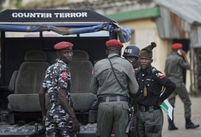 FILE- Counter-terror and regular police provide security at the offices of the Independent National Electoral Commission in Kano, northern Nigeria Thursday, Feb. 14, 2019. Nigeria's police on Friday, June 3, 2022 said they are still looking for suspects in the abduction of the head of the Methodist Church Nigeria who was freed in exchange for a ransom of 100 million naira ($240,600). Samuel Kanu Uche was freed on Monday, a day after he was kidnapped in Abia in southeast Nigeria, the Christian Association of Nigeria said.(AP Photo/Ben Curtis,File)