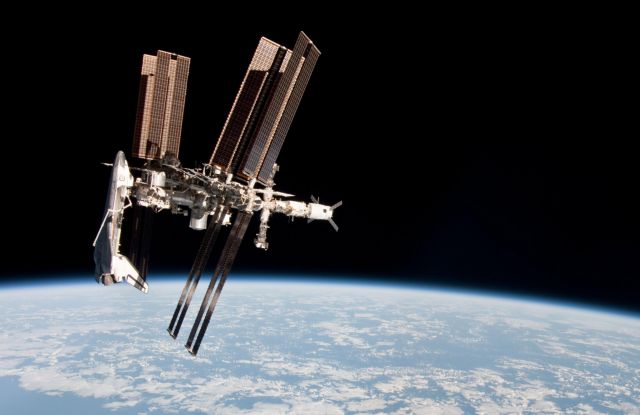 This May 23, 2011 photo made by Expedition 27 crew member Paolo Nespoli from the Soyuz TMA-20 following its undocking and released by NASA shows the International Space Station and the docked space shuttle Endeavour, left, at an altitude of approximately 220 miles. A Soyuz capsule had never headed for home while a shuttle was parked at the space station, providing a rare opportunity for the photo session. (AP Photo/NASA, Paolo Nespoli)