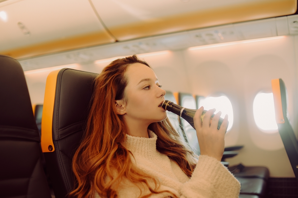 The,Girl,In,The,Plane,Drinks,Champagne,Alcohol,From,Excitement.