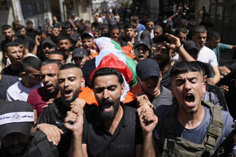 Mourners carry the bodies of Palestinians Ahmed Sheikh Khalil, 20, front and Wael Misha, 18, both killed by an airstrike overnight during an army operation in the occupied West Bank, during their funeral in the refugee Camp of Balata, in Nablus, Thursday, Aug. 15, 2024. (AP Photo/Nasser Nasser)