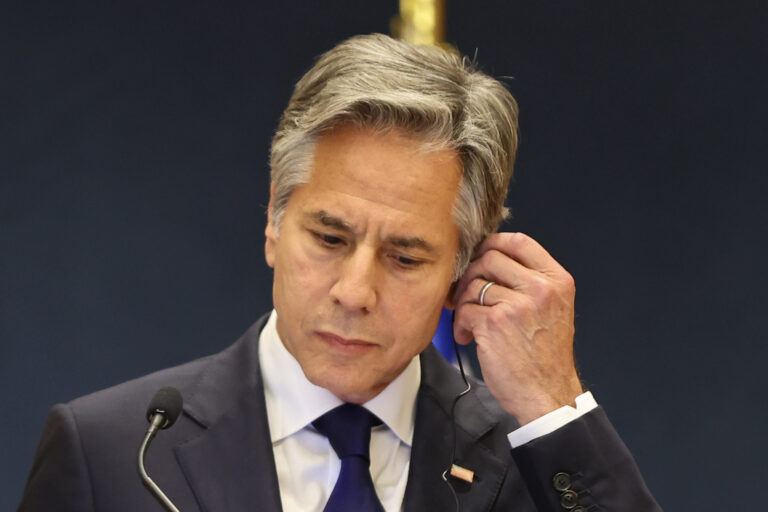 US Secretary of State Antony Blinken adjusts his earpiece at a joint press conference with the Qatari Prime Minister Sheikh Mohammed Bin Abdulrahman al-Thani in Doha, Qatar, Wednesday, June 12, 2024. (Ibraheem Al Omari/Pool Photo via AP)