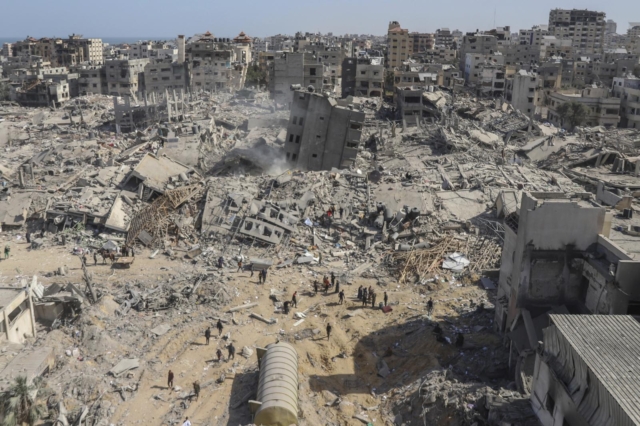 FILE - Destroyed buildings are seen in the Gaza Strip from southern Israel, Monday, Nov. 20, 2023. In Israel's drive to destroy Hamas, some rights groups and aid workers say Israel seems to have given itself wide leeway to determine what is a target and how many civilian deaths it allows as collateral damage. Israel says it's targeting Hamas and blames the civilian death toll on militants operating among the population. (AP Photo/Leo Correa, File)