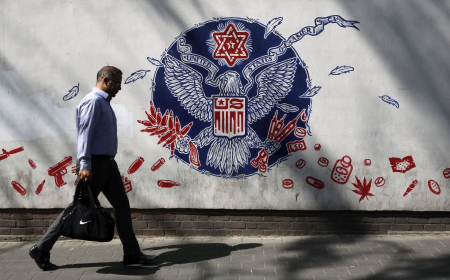 epa10802862 An Iranian man walks past an anti-US mural around the former US embassy in Tehran, Iran, 16 August 2023. US Secretary of State Antony Blinken confirmed on 15 August that Iranian authorities released five US citizens from prison to house arrest. Iranian Foreign Ministry spokesman Nasser Kanaani said on 14 August his country received the necessary guarantees from the US on a recent prisoner swap agreement and release of Iran's frozen funds that was the outcome of two years of negotiations between the two countries.  EPA/ABEDIN TAEHRKENAREH