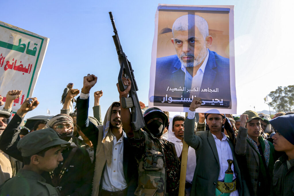 Supporters of Yemen's Huthis chant slogans as they gather with a picture of Hamas' slain leader Yahya Sinwar during a rally held in the Huthi-controlled capital Sanaa on October 18, 2024 in protest against Israel's attacks on Lebanon and the ongoing war between Israel and Hamas militants in the Gaza Strip. Israel announced on October 17 the killing of Sinwar, mastermind of the October 7 attack, calling his death a "heavy blow" to the Palestinian group it has been fighting for more than a year. (Photo by Mohammed HUWAIS / AFP)