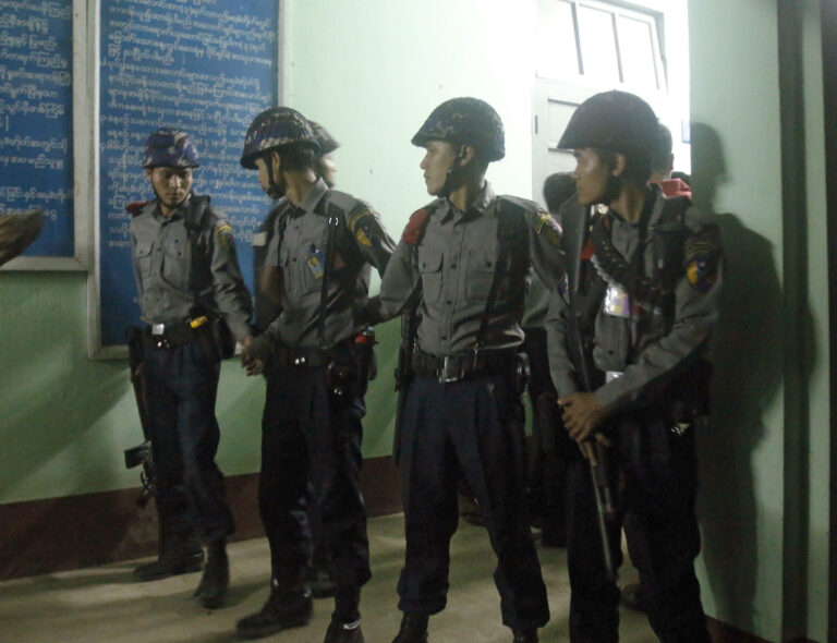 Polices provide security at the mortuary building of the hospital in north Okalapa township, outskirt of Yangon, Myanmar, Sunday, Jan.29, 2017. A gunman killed a legal adviser for Myanmar's ruling National League for Democracy on Sunday, shooting the lawyer in the head at close range as he walked out of the Yangon airport, the government said. (AP Photo/Thein Zaw)