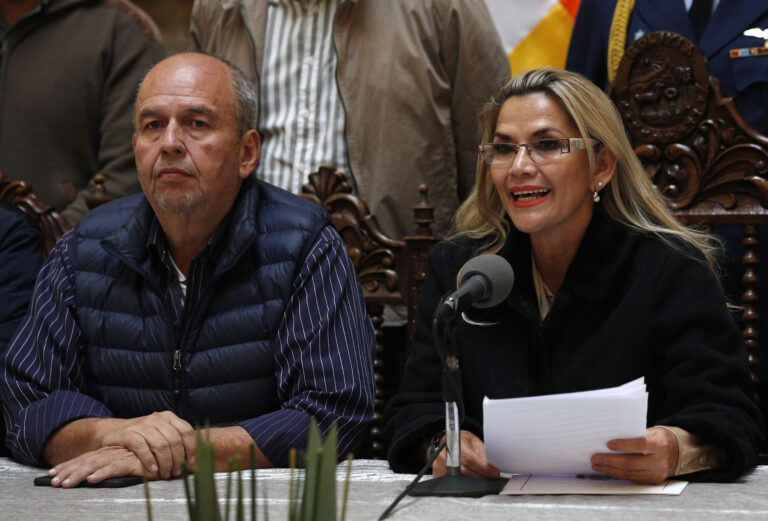 FILE - Accompanied by Interior Minister Arturo Murillo, Bolivia's interim President Jeanine Añez speaks during a press conference at the presidential palace, in La Paz, Bolivia, Nov. 23, 2019. According to a US Department of Justice statement on Wednesday, May 26, 2021, The former Bolivian interior minister was sentenced to nearly six years in U.S. prison Wednesday, Jan. 4, 2023, for taking at least $532,000 in bribes to help a Florida company win a lucrative contract to sell tear gas to his country's government. (AP Photo/Juan Karita, File)