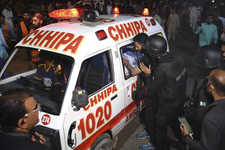 Police officers look a body, a victim of gunmen attack at a police headquarters, loaded in ambulance at a hospital, in Karachi, Pakistan,Friday, Feb. 17, 2023. Militants launched a deadly suicide attack on the police headquarters of Pakistan's largest city on Friday, officials said, as the sound of gunfire and explosions rocked the heart of Karachi for several hours. (AP Photo)