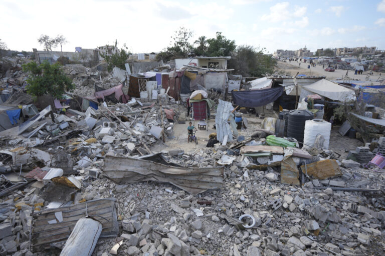 A displaced child stands amidst the debris of a bombed home in Khan Younis, Gaza Strip, Sunday, Sept. 15, 2024. (AP Photo/Abdel Kareem Hana)