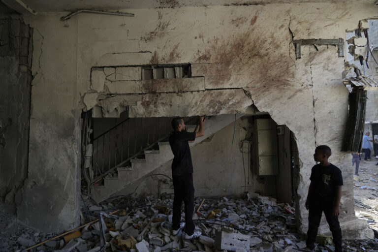 Palestinians examine the damage following an Israeli airstrike in the West Bank city of Tulkarem, which Palestinian health officials say killed 18 people and the Israeli military says took out a Hamas leader, on Friday, Oct. 4, 2024. (AP Photo/Nasser Nasser)