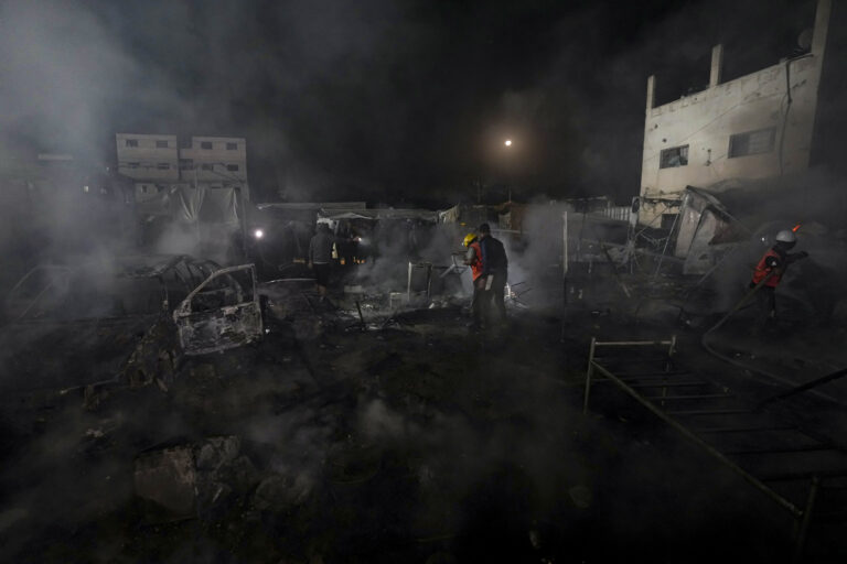 Palestinian firefighters try to extinguish a fire caused by an Israeli strike that hit a tent area in the courtyard of Al Aqsa Martyrs hospital in Deir al Balah, Gaza Strip, Monday, Oct. 14, 2024. (AP Photo/Abdel Kareem Hana)